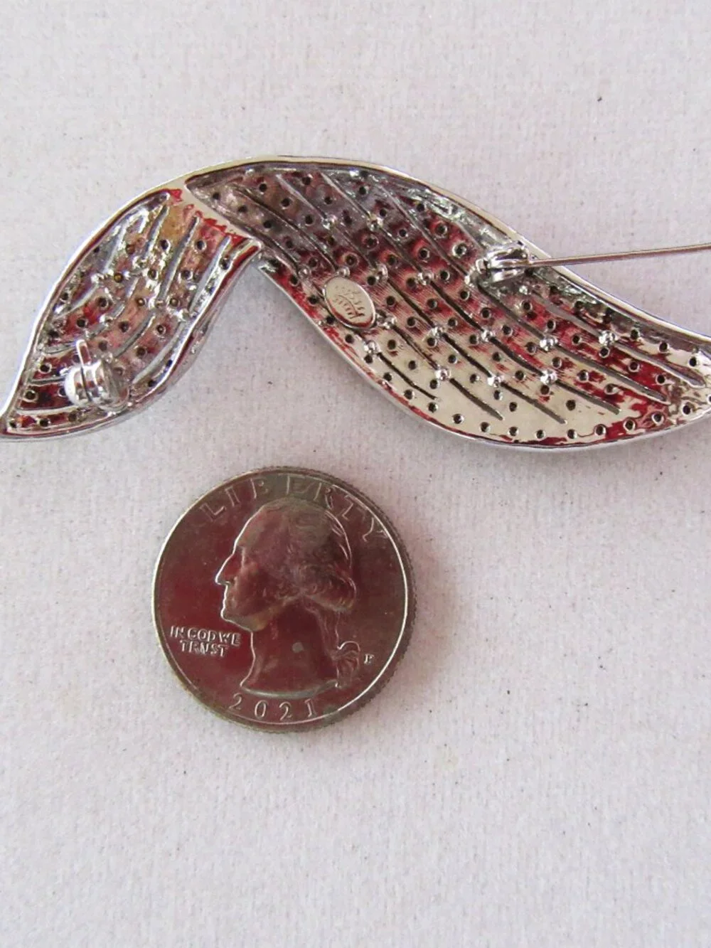 Clear pave rhinestone free form ribbon brooch in silver tone setting